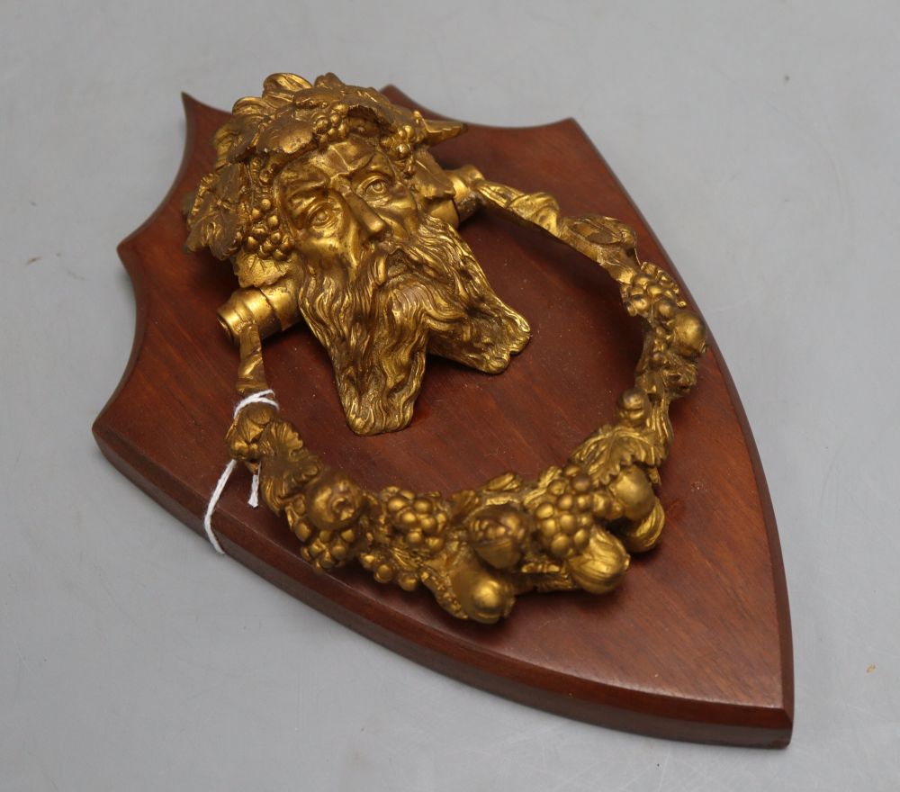 A 19th century Bacchus ormolu door knocker, on shield mount